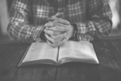 Man%20with%20hands%20on%20bible%20 %20black%20and%20white